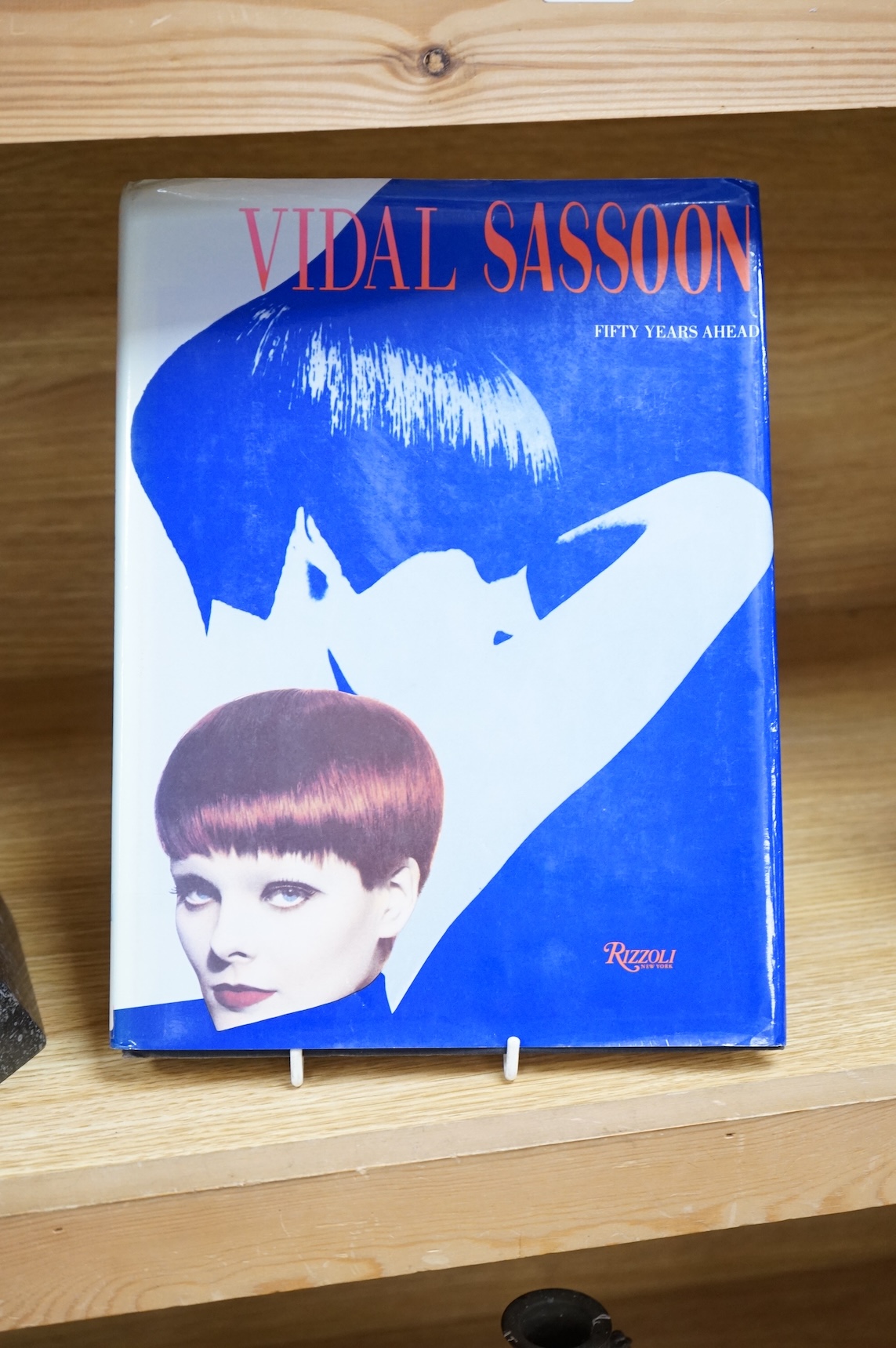 A figural bronze award: Alternative Hair Show Award Vidal Sassoon for 50 Years Creativity October 1993, together with Vidal Sassoon Fifty Years Ahead, a photographic history of his work. Award 29cm wide x 25cm high.